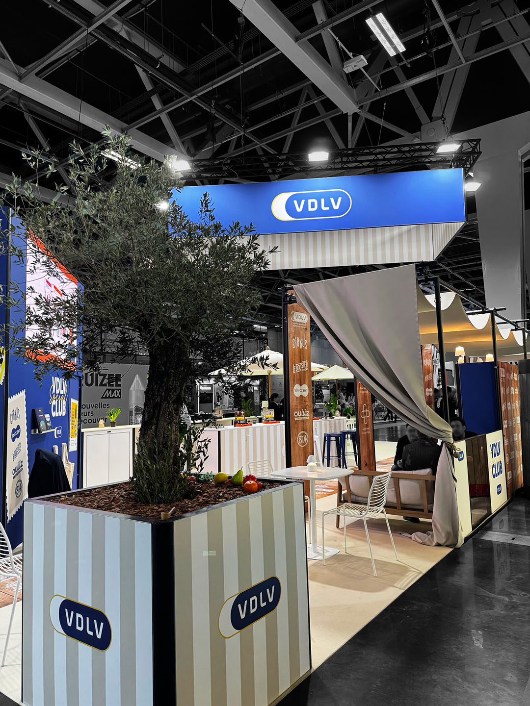 VDLV booth—close-up of the back with the olive tree